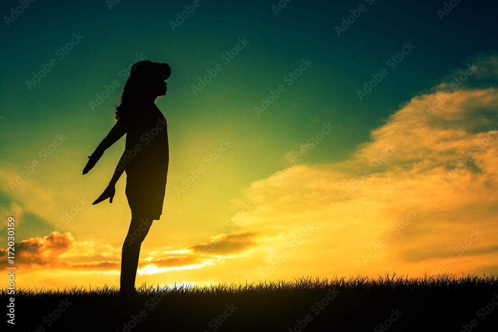 Young woman relaxing in silhouette sunset sky outdoor.