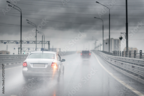 Drive car in rain on asphalt wet road