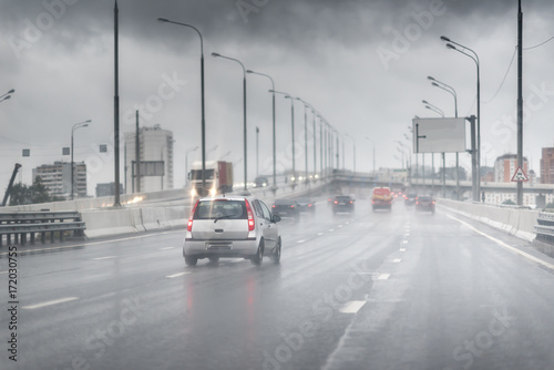 Drive car in rain on asphalt wet road photo
