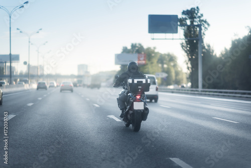 Motorcycle riding on a wet road © Mak