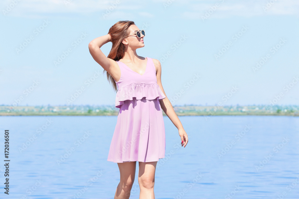 Beautiful young woman on embankment in sunny day Beautiful young woman on embankment in sunny day