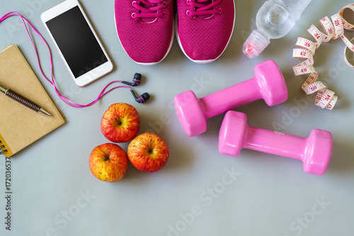Fitness, healthy and active lifestyles Concept, dumbbells, smart phone, sport shoes, tape measure, bottle of water, notebook on wood background. top view with blank copy space © ezstudiophoto