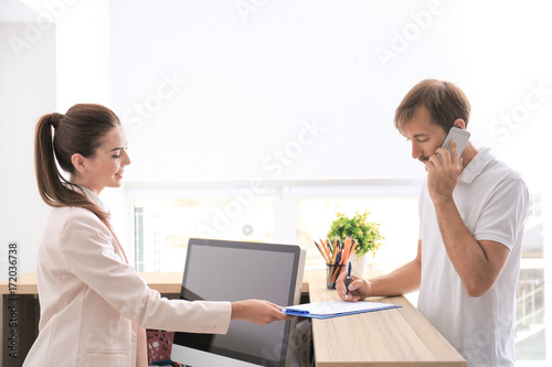 Young female receptionist m...