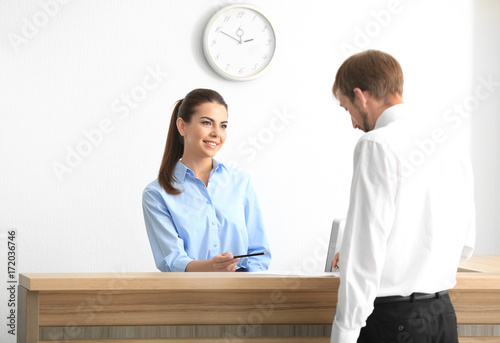 Young female receptionist m...