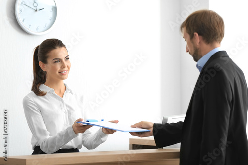Young female receptionist m...