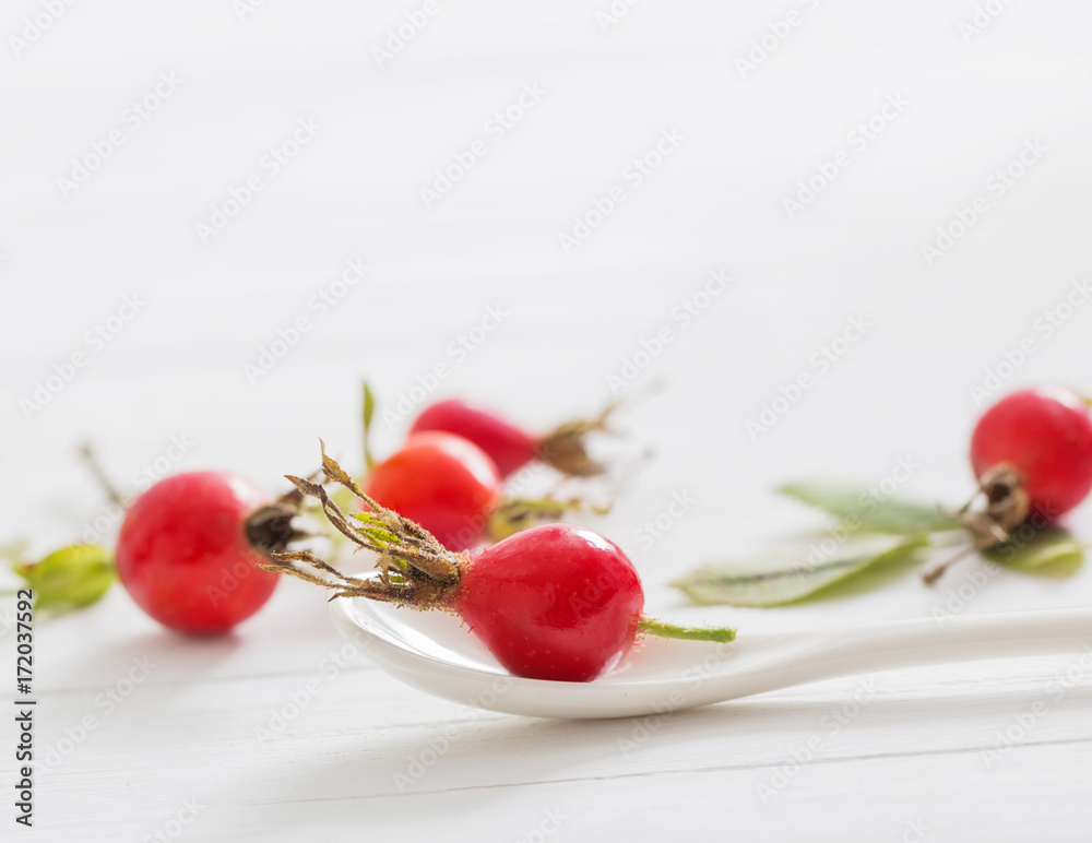 berries of a dogrose on a wooden background berries of a dogrose on a wooden background