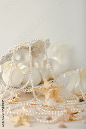 Christmas and New Year. Christmas-tree white toys in a marine style, seashells stones and starfish.