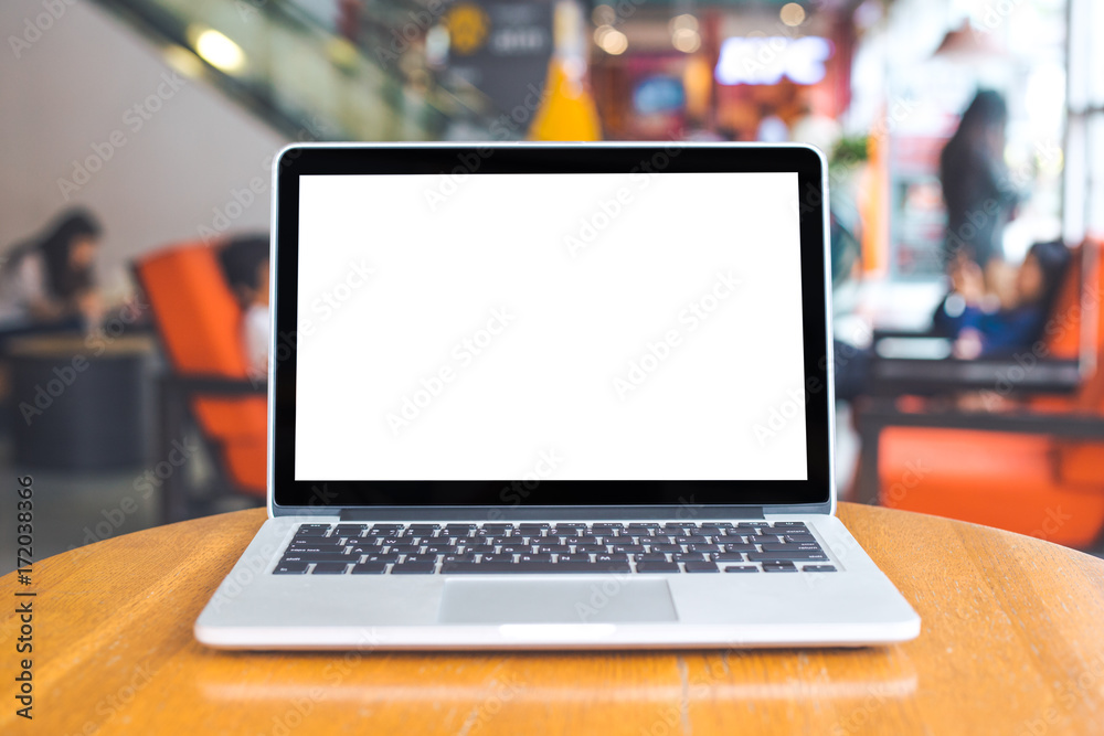 Laptop computer with blank white screen on a wooden table, blurred background Laptop computer with blank white screen on a wooden table, blurred background