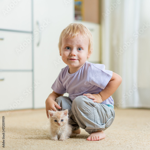 Toddler kid boy playing wit...