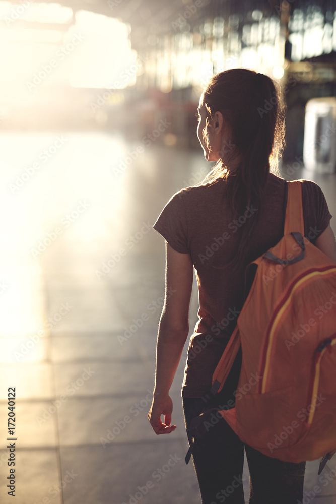 Φωτογραφία young woman in the hall of the airport terminal with small backpack as a hand luggage