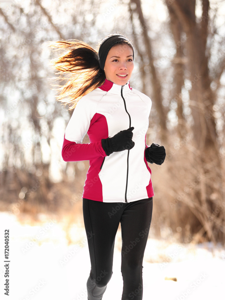 Winter runner woman jogging outside in forest. Jogger fit Asian girl  running outdoor breathing cold air wearing sportswear windproof jacket,  tights, gloves and ear warmers headband. Stock Photo | Adobe Stock