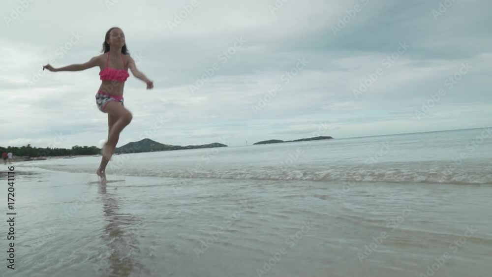Joyful happy young girl running on water sea spray slow motion stock footage video Joyful happy young girl running on water sea spray slow motion stock footage video