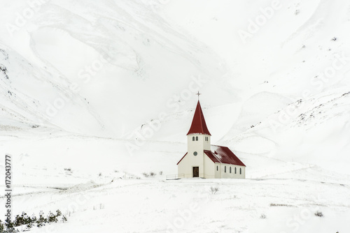 Fototapeta Beautiful church among the mountains in winter.