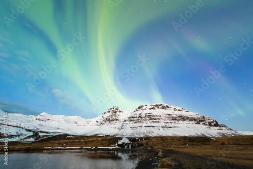 The Northern Light, Aurora borealis over Kirkjufellfoss before sunrise, Iceland.