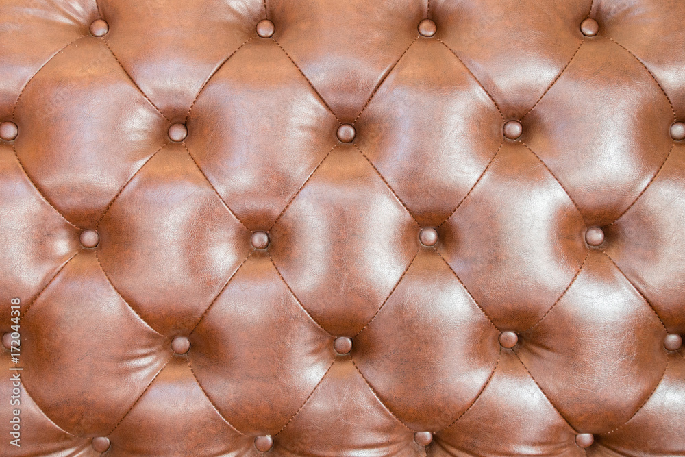 Brown leather texture with buttons for background. Brown leather texture with buttons for background.