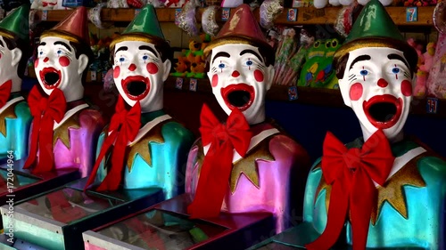 Iconic laughing clowns game stand, HD real time, handheld.