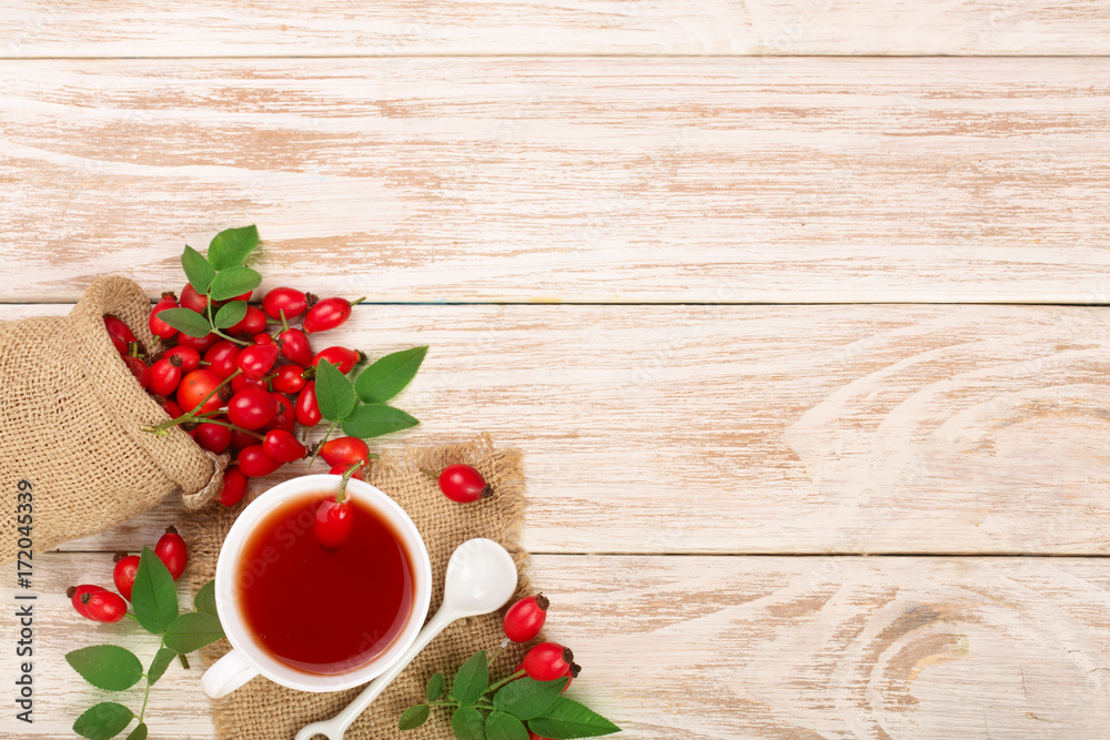tea with rose hips and honey on white wooden background with copy space for your text. Top view tea with rose hips and honey on white wooden background with copy space for your text. Top view