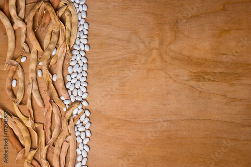 Dry beans on a wooden background with space for text