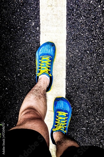 Close up runner legs on white line