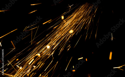 Sparks from metal on construction site as background