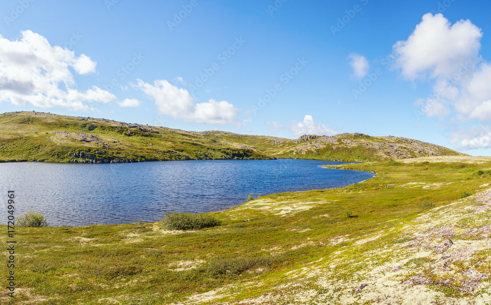 Blue lake water in the mountain tundra