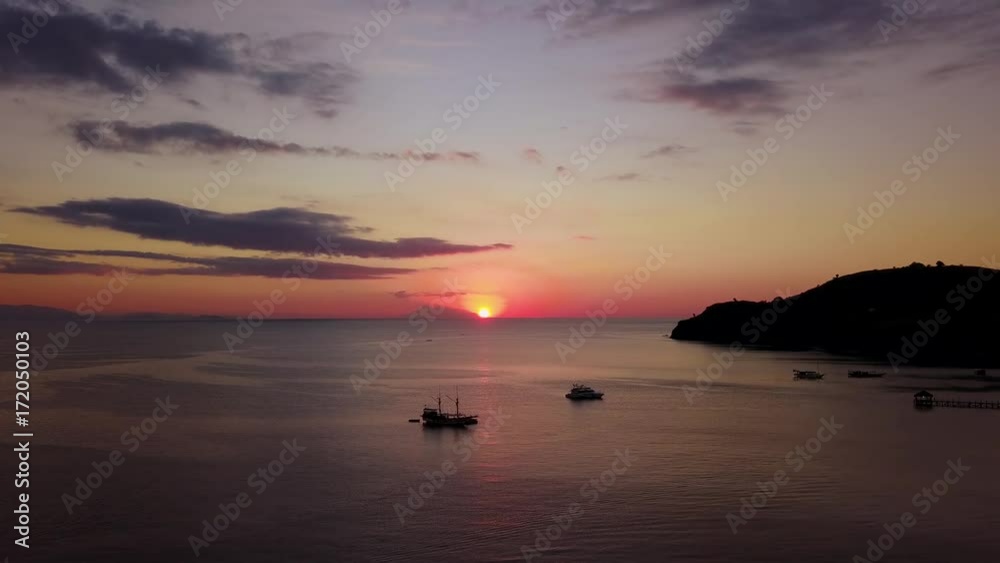 Exotic aerial scenery of sunset above the sea from a drone flying forward in Labuan Bajo at Flores Island close to Bali, Indonesia. Shot in 4k resolution Exotic aerial scenery of sunset above the sea from a drone flying forward in Labuan Bajo at Flores Island close to Bali, Indonesia. Shot in 4k resolution