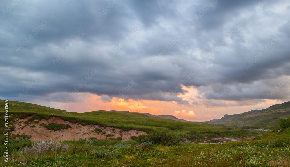 Sunset through the rain clouds in the tundra Sunset through the rain clouds in the tundra