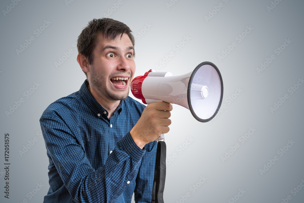 Young man is announcing news with megaphone. Young man is announcing news with megaphone.