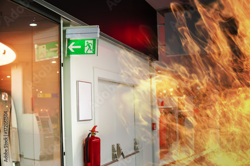 Emergency fire exit sign and fire in shopping mall.