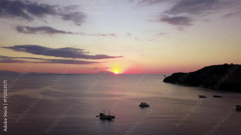 Stunning aerial landscape of sunset on the sea with silhouette of boats in Labuan Bajo at Flores Island near Bali, Indonesia. Shot in 4k resolution Stunning aerial landscape of sunset on the sea with silhouette of boats in Labuan Bajo at Flores Island near Bali, Indonesia. Shot in 4k resolution