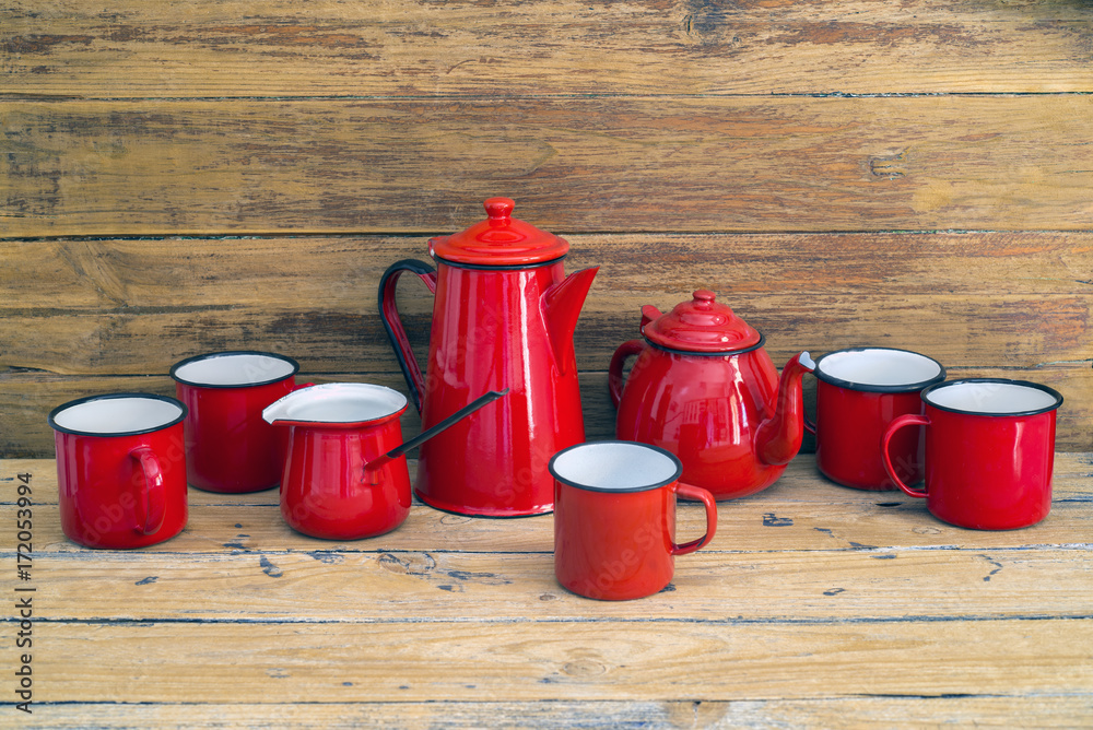 teapot, jug for milk and cups of red color teapot, jug for milk and cups of red color