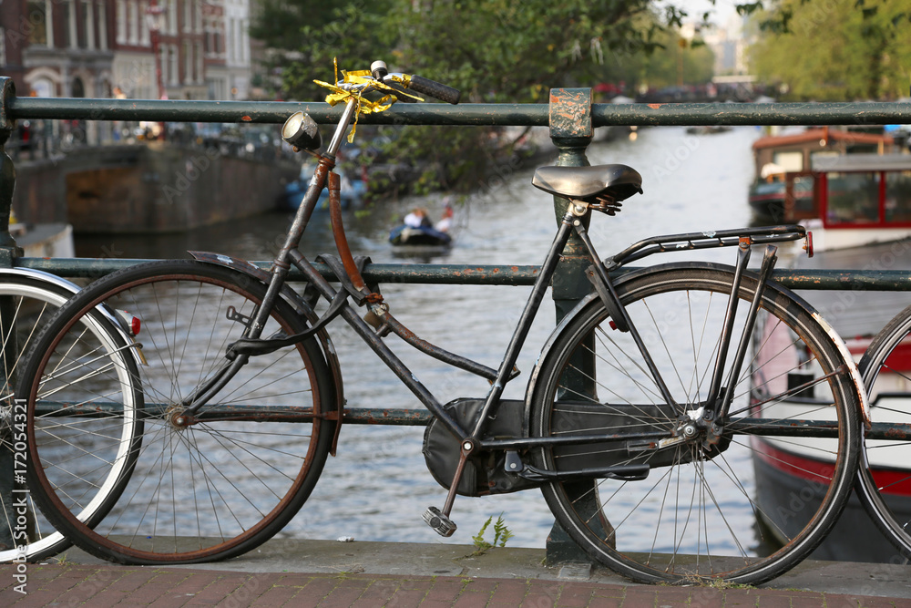 black bicycle over the bridge in Amsterdam city
