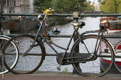 black bicycle over the bridge in Amsterdam city #172054321