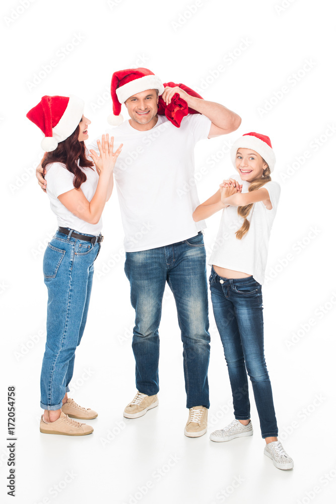 Obraz premium Happy family in Santa hats