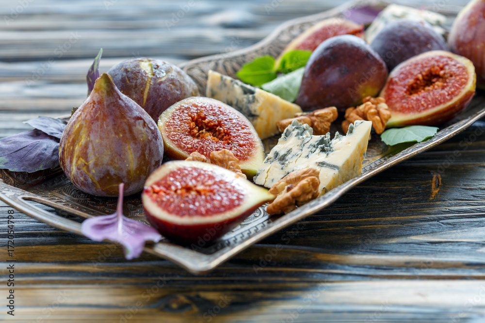 Figs,blue cheese and walnuts on a bronze tray. Figs,blue cheese and walnuts on a bronze tray.