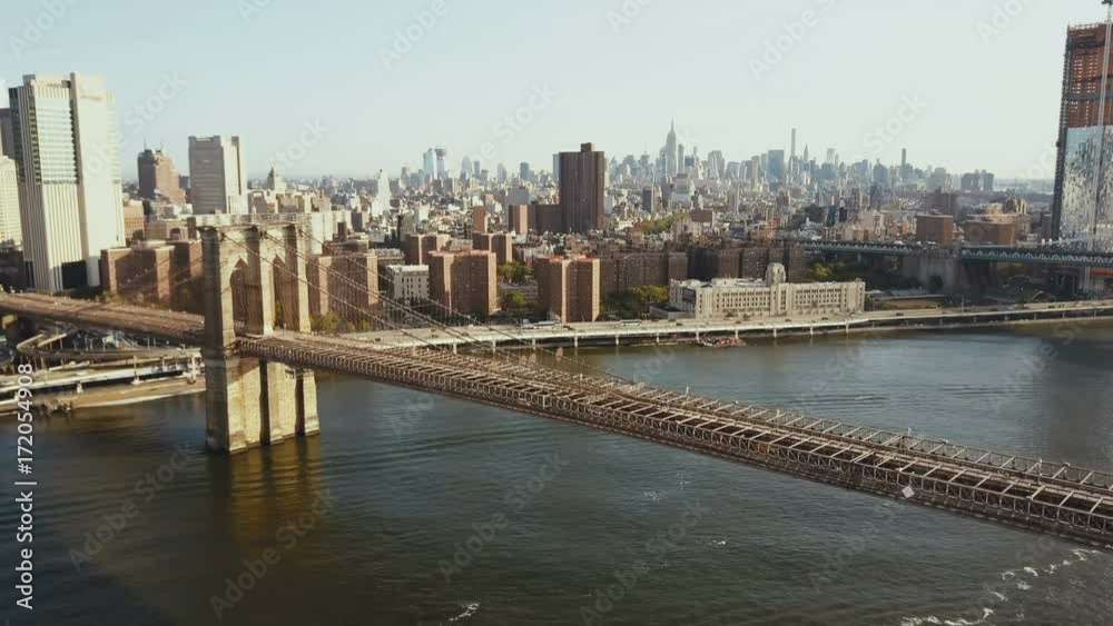 Aerial view of the Brooklyn bridge, Manhattan district in New York, America. Drone flying over the East river. Aerial view of the Brooklyn bridge, Manhattan district in New York, America. Drone flying over the East river.
