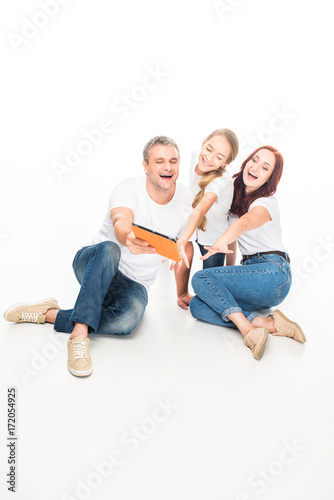 family using digital tablet