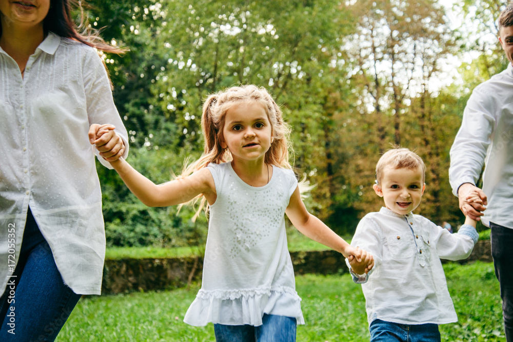 Fototapeta premium happy family running in city park