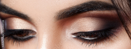 Closeup shot of woman eye with evening makeup. Long eyelashes. Smokey Eyes