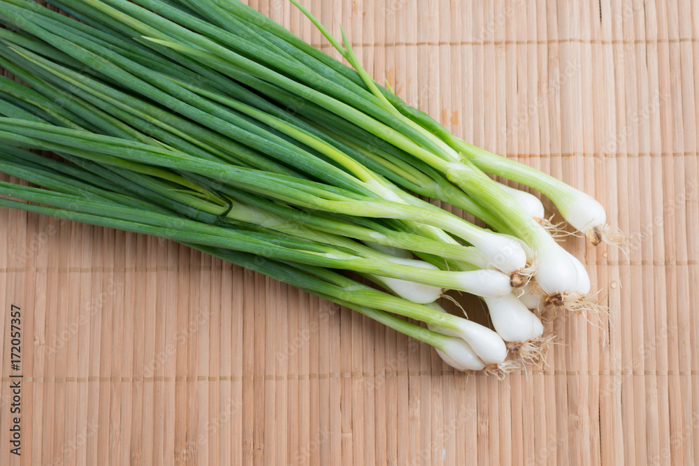 Pile of fresh spring onion on wood table Pile of fresh spring onion on wood table