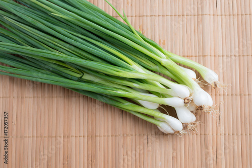 Pile of fresh spring onion on wood table