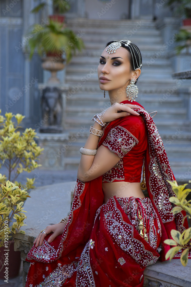 Beautiful young indian woman in traditional clothing with bridal makeup