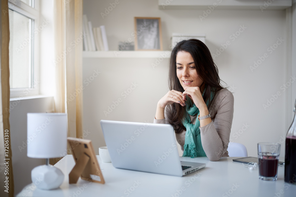 Caucasian freelancer working on laptop at home office Caucasian freelancer working on laptop at home office