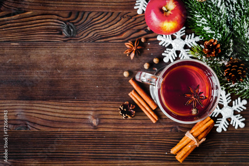 cup with christmas mulled wine on wooden background top view