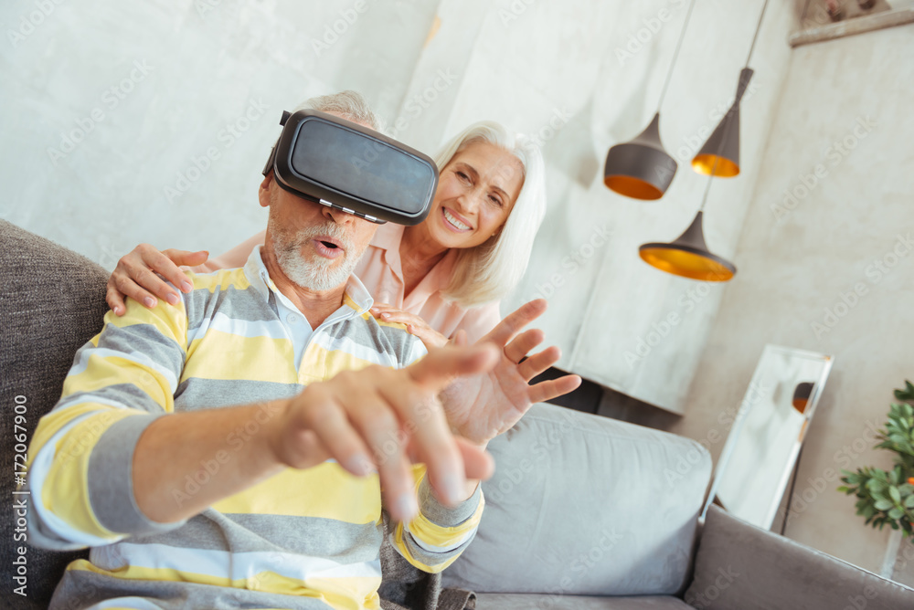 Retired aged man trying up VR glasses Retired aged man trying up VR glasses
