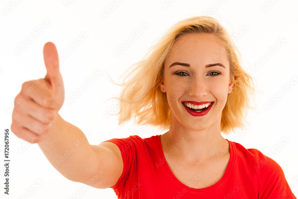 Attractive blonde woman shows thumb up as a gesture for success isolated over white background Attractive blonde woman shows thumb up as a gesture for success isolated over white background