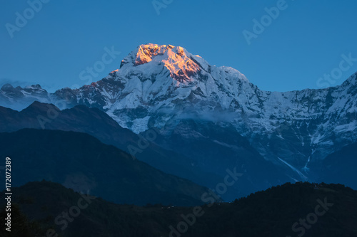 First ray of sunlight on the snow capped peaks.