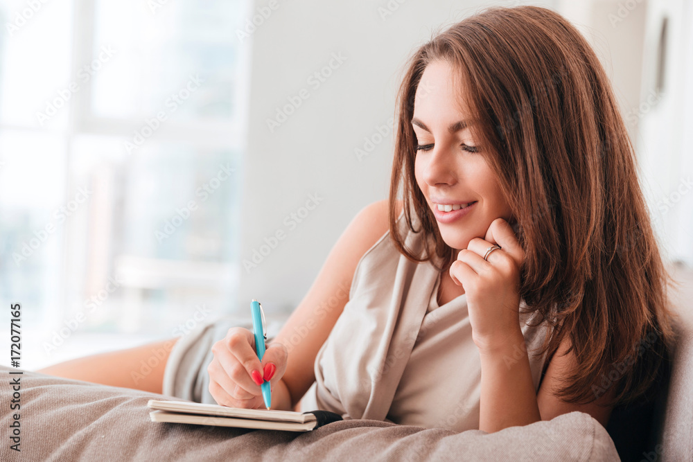 Close up portrait of a beautiful young woman writing notes Close up portrait of a beautiful young woman writing notes