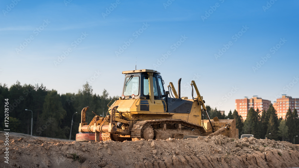 Obraz premium Yellow Construction bulldozer at Work