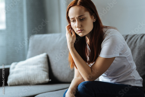 Cheerless depressed woman holding her hair